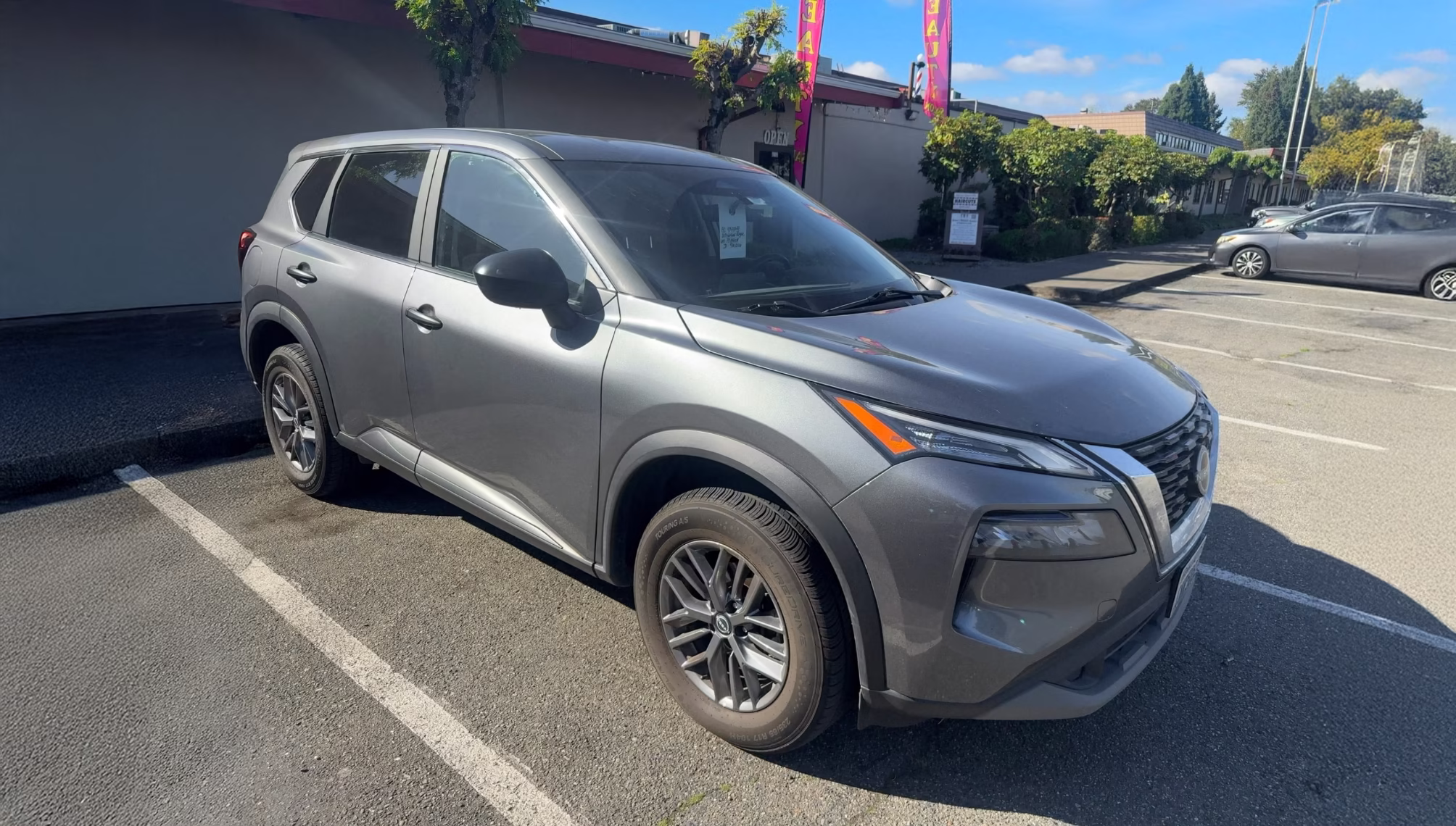 Grey 2023 Nissan Rogue parked in a dealership lot